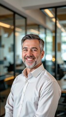 Obraz premium Smiling Professional Man in Modern Office Space: Leadership, Confidence, and Approachability