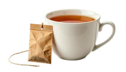 Creamy white mug with amber tea next to a tea bag