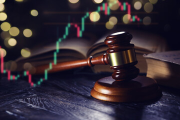 Wooden judge gavel and legal book on wooden table