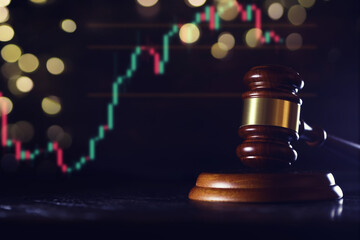 Wooden judge gavel and legal book on wooden table