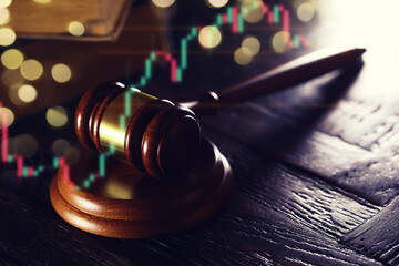 Wooden judge gavel and legal book on wooden table