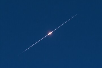 Rocket soaring through the dark blue sky with leaving a bright vapor trail Space flight.