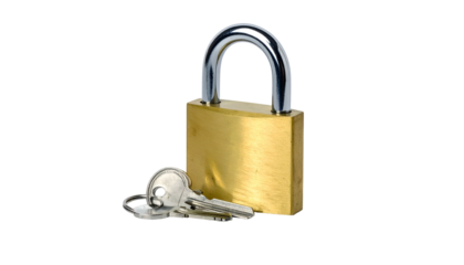 A close-up shot of a brass padlock with a shiny, silver shackle, and a set of keys resting beside it. Isolated on a black background