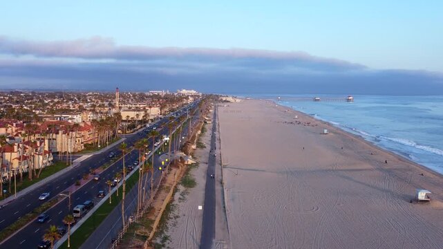 Coastal sunset view of Huntington Beach, Orange County, California - Pacific West Coast. Aerial Landscape looking toward HB Pier and residential ocean front neighbourhoods along PCH Highway.