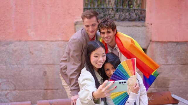 Group of lgbt friends taking a selfie with a rainbow flag