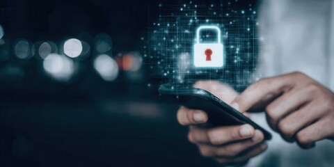 mobile phone held in hand with virtual padlock icon blue light cyber shield concept showing data protection password safety and secure online privacy technology