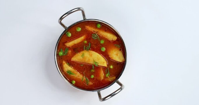 Potato curry or aloo or aaloo masala fry with green peas, indian main course food, selective focus