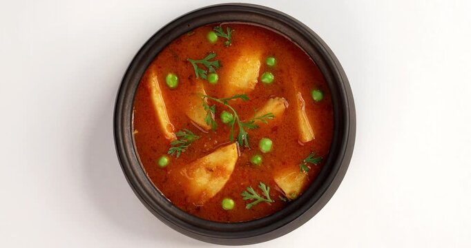 Potato curry or aloo or aaloo masala fry with green peas, indian main course food, selective focus
