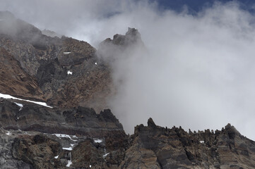 The enchanting beauty of the snowy mountains. The view of snow and rocks on the mountain tops.