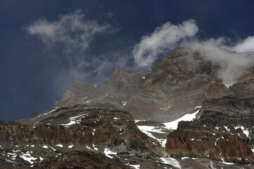 The enchanting beauty of the snowy mountains. The view of snow and rocks on the mountain tops.