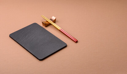 A black slate stone board or plate, an empty kitchen utensil. A black slate board