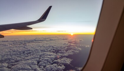 Airplane Window View of Sunrise Over Clouds.