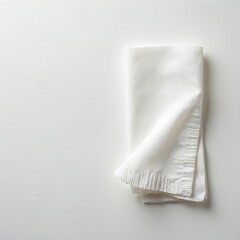 Single white paper napkin folded neatly on clean table surface. Minimalist design for dining settings, catering events, or restaurant menus. Use for meal prep and food service presentation.