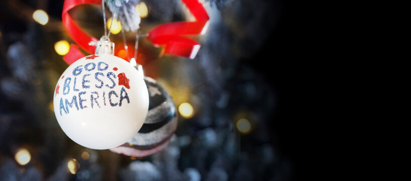 God bless America is depicted on a Christmas tree ball. The National flag of the United States of America. Christmas and New Year in the USA.