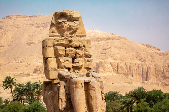 The Colossi of Memnon in Luxor, Egypt. The Colossi of Memnon, two colossal statues of Pharaoh Amenhotep III. Historical statues of ancient Egypt.
