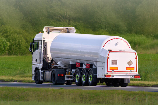 Chemical transport truck moving along rural highway