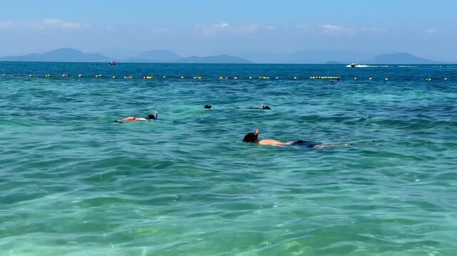 tourists snorkeling with a mask in the Andaman Sea. 4k video