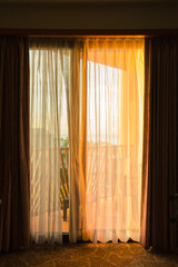 Warm Morning Light Through Sheer Curtains in Cozy Bedroom