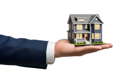 A miniature model house is being held in someone's hand, showcasing a gray structure with multiple lit windows