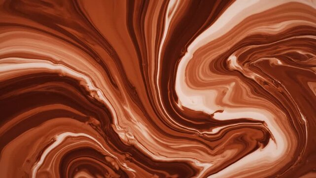 A delicious dark chocolate background features smooth melted chocolate dripping over a textured melted chocolate background with a creamy liquid swirl of sweet cocoa