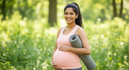 Happy pregnant Indian woman with yoga mat outdoors