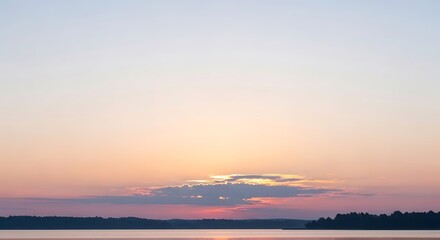 Fototapeta premium Serene Sunset Over Calm Water with Distant Tree Line.