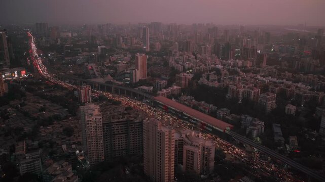 Evening view of a metropolis city from the top showing the cityscape, skyscrapers, houses, and traffic.