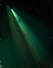A dramatic, green-hued light burst slanting across a dark background