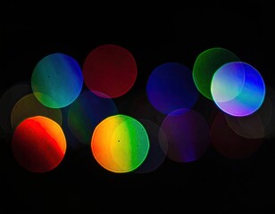 Out-of-focus colored orbs, luminous against a stark, black backdrop