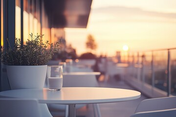 Modern rooftop terrace with white tables, glass of milk, potted plant at sunset. Tranquil evening setting, urban lifestyle, warm colors.