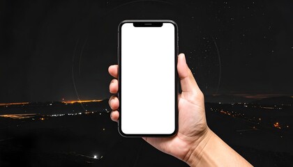 Hand holding smartphone with blank screen against a city nightscape