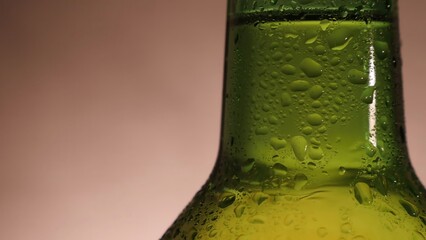 Cold refreshing beer bottle with condensation drops