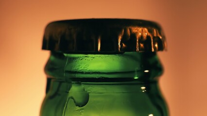 Green beer bottle close up with condensation