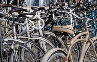 Fotobehang Fiets A lot of old bicycles different brand names parked on the street.  © num