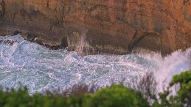 Close up of waves pushing towards sea cliff, Loch Ard Gorge, Great Ocean Road, Port Campbell, Victoria, Australia
