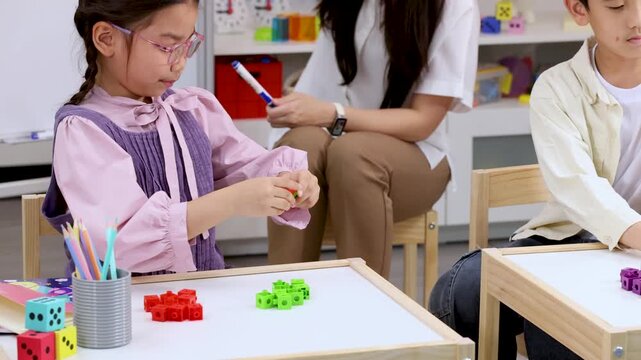 Elementary Students Learning Math With Colorful Counting Blocks