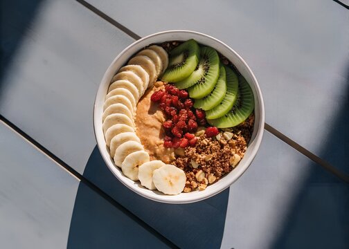 Healthy granola bowl with banana kiwi and berries