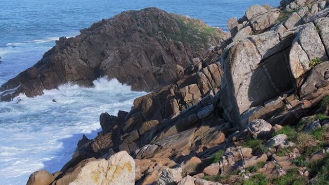 Rocky Sea Cliffs With Crashing Waves At Senda Azul (Paseo Mar&iacute;timo de Arteixo) In Arteixo, A Coru&ntilde;a, Spain. Aerial Sideways Shot