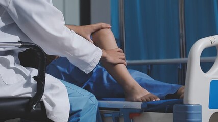 Asian physical therapist nurse is performing physical therapy to rehabilitate the legs of an elderly female patient.