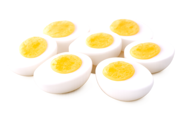 Golden yolks of sliced hard-boiled eggs arranged neatly against a clean white backdrop.