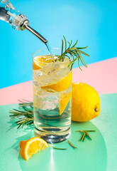 Refreshing cocktail with gin, tonic, lemon, and rosemary.