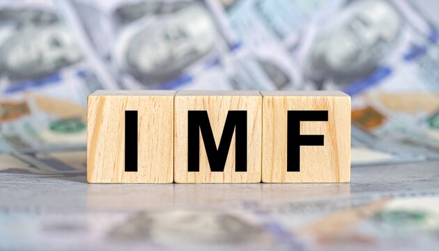 &ldquo;IMF&rdquo; wooden blocks on dollar bill background