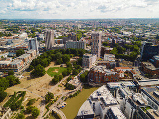 Bristol England: 28th Jul 2025: Scenic topdown drone view of Bristol castle park along the Feeder canal to river Avon with city skyline backdrop