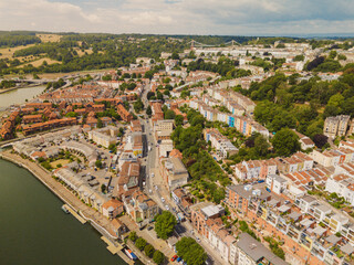 Bristol UK: 28th July 2025: Drone perspective captures the vibrant housing architecture in Bristol Harbourside with Clifton Suspension Bridge on the horizon