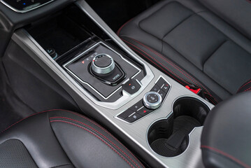 The center console of a sports car with luxury features.