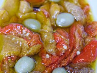 Roasted peppers in olive oil with green olives