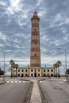 Farol de Barra, lighthouse on the beach at the atlantic coast in Costa Nova do Prado, Aveiro, Portugal.