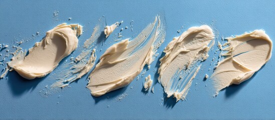 Creamy Cosmetic Product Smears on Soft Blue Background