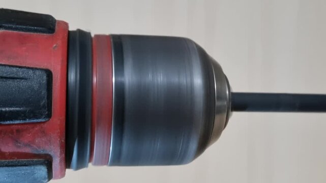 Macro detail shot of a spinning drill bit tip on a power tool demonstrating rotation stability and torque