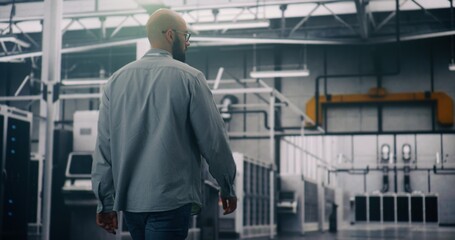 Security Oversight, Data Center Specialist Monitoring Access and Safety. Specialist Walking and Monitoring Security, Access Within Glowing Server Room. Concept Data Security and Facility Surveillance.